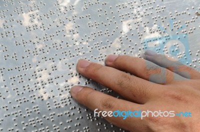 Close Up Hand Reading Braille Stock Photo