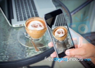 Close Up Hand Taking Photo Coffee On Work Table Stock Photo