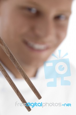 Close Up Of Chopsticks And Chef In Blur Motion Stock Photo