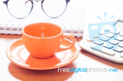 Close Up Of Coffee Cup With Book And Eyeglasses Stock Photo