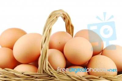 Close-up Of Eggs In A Wicker Basket On White Stock Photo