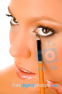 Close Up Of Female Putting Liner Stock Photo