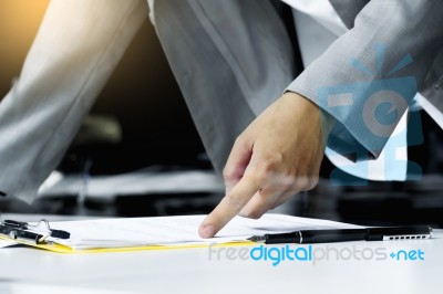 Close-up Of Human Hand With Pen Pointing At Paper While Explaini… Stock Photo