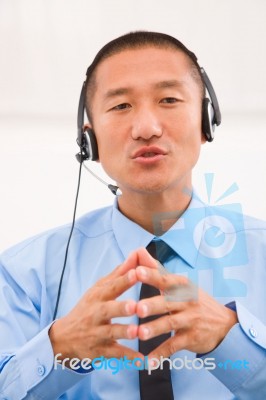 Close-up Of Male Customer Service Representative Wearing Headset… Stock Photo