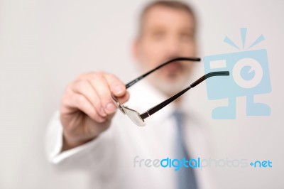 Close-up Of Male Hand Holding Eyeglasses Stock Photo