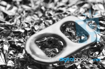 Close Up Of Metal Ring Pulls On Foil Background Stock Photo