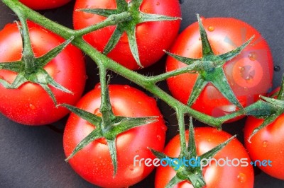 Close-up Of Some Ripe Tomatoes On The Vine Stock Photo