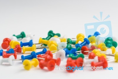 Close Up Of Various Pushpins On White Background Stock Photo