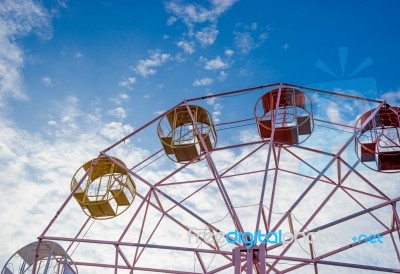 Close Up Part Of Pastel Ferris Wheel On Blue Sky Stock Photo