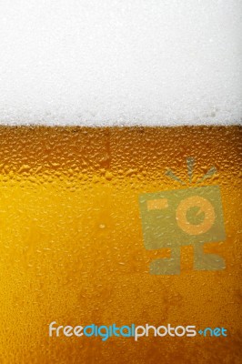 Close-up Picture Of A Beer With Foam And Bubbles Stock Photo