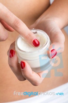 Close Up Portrait Of Woman Applying Cream On Hands Stock Photo