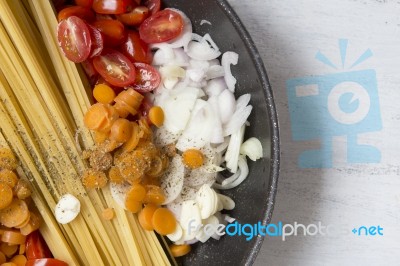 Close Up Raw Spaghetti With Fresh Vegetables In The Pan Stock Photo