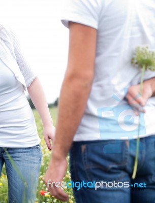 Close Up Shot Of A Boyfriend Hiding A Flower Stock Photo