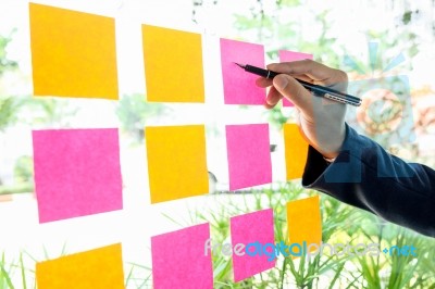 Close Up Shot Of Hands Of Woman Sticking Adhesive Notes On Glass… Stock Photo