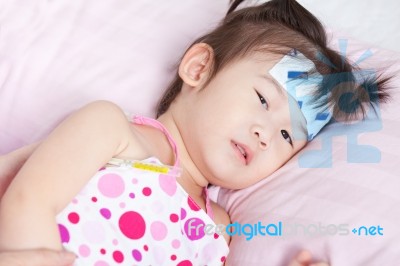 Close Up Sick Little Asian Girl With Mercury Thermometer Stock Photo