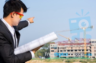 Close Up The Young Businessman Holds A Blueprint And Points To T… Stock Photo