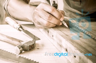 Close Up View Of A Carpenter Using A Straightedge To Draw A Line… Stock Photo