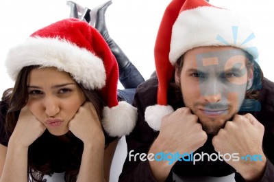 Close Up View Of Young Couple Wearing Christmas Hat And Looking At Camera Stock Photo