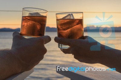 Close Up View Sunset Cocktails On Ice Stock Photo