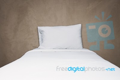 Close Up White Bedding And Pillow On Gray Concrete Background Stock Photo