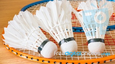 Close Up White Shuttlecock On Wooden Background Stock Photo