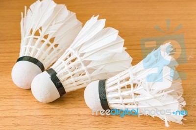 Close Up White Shuttlecock On Wooden Background Stock Photo