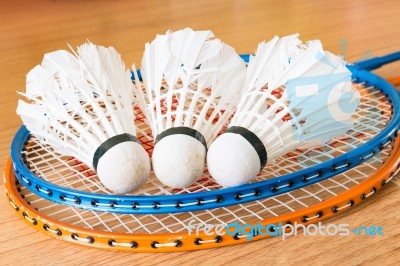 Close Up White Shuttlecock On Wooden Background Stock Photo