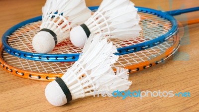 Close Up White Shuttlecock On Wooden Background Stock Photo