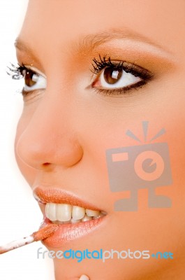 Close View Of Woman Putting Lipstick Stock Photo