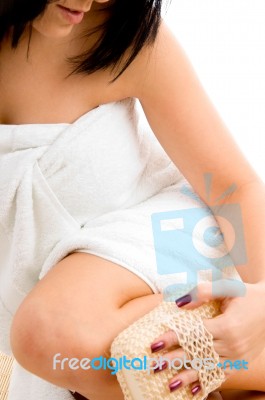 Close View Of Woman Scrubbing Her Leg With White Background Stock Photo