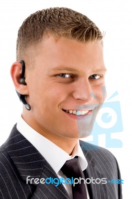 Close View Of Young Executive With Blue Tooth Stock Photo