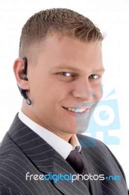 Close View Of Young Executive With Blue Tooth Stock Photo