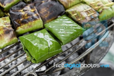 Closeup Fish In Banana Leaf On The Grill Stock Photo