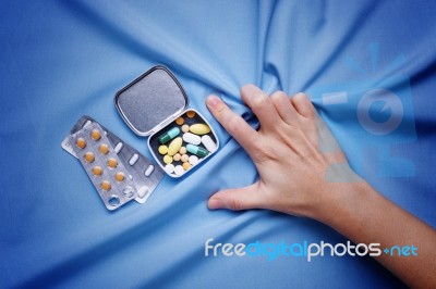 Closeup Hand Trying To Take Pills With Pain And Suffer Stock Photo