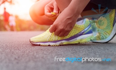 Closeup Hand Tying Laces Ready For Run On Road At Sunset Stock Photo