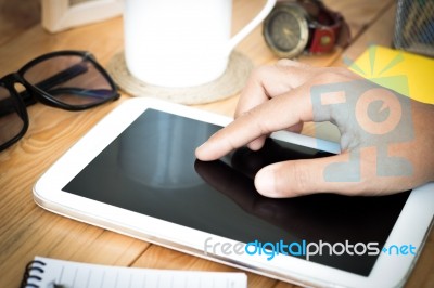 Closeup Hand Using Digital Tablet On Workspace Stock Photo