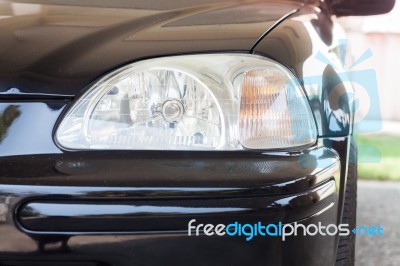 Closeup Headlight Of Black Coupe Stock Photo