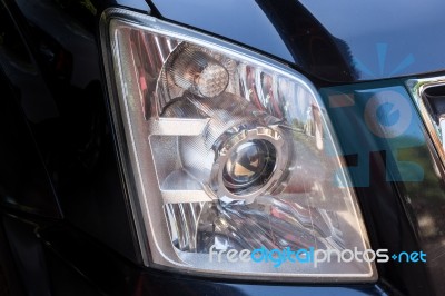 Closeup Headlights Of Modern Black Car With Projector Lens Stock Photo