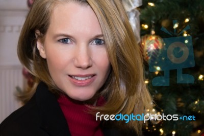 Closeup Of Blonde Female And Christmas Tree Stock Photo