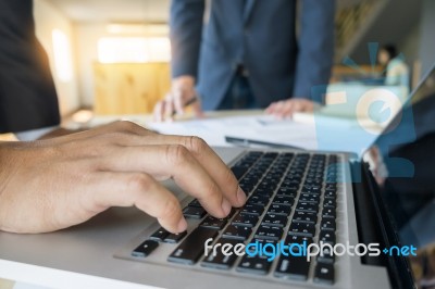 Closeup Of Businessman Is Keyboarding On Portable Net-book, Whil… Stock Photo