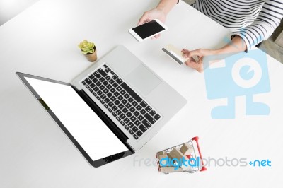 Closeup Of Happy Young Woman Holding Credit Card Inputting Card Stock Photo