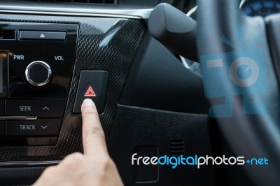 Closeup Of Young Woman Pressing Emergency Button On Car Sport Dashboard Stock Photo