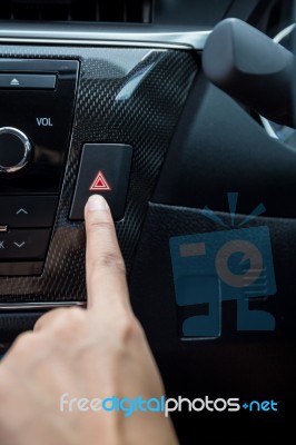 Closeup Of Young Woman Pressing Emergency Button On Car Sport Dashboard Stock Photo