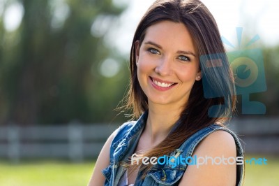 Closeup Portrait Of Cute Young Woman In The Park Stock Photo