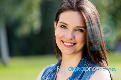 Closeup Portrait Of Cute Young Woman In The Park Stock Photo