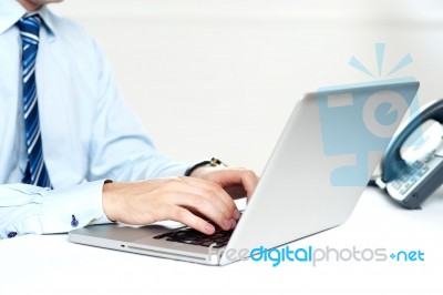 Closeup Shot Of Man Working On A Laptop Stock Photo