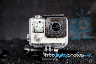 Closeup Water Splash On Extreme Camera  In Waterproof Stock Photo