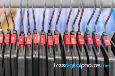 Cloth Hanger With Red Sizing Label In Row Stock Photo