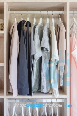 Clothes Hanging In Wooden Wardrobe Stock Photo