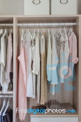 Clothes Hanging In Wooden Wardrobe Stock Photo